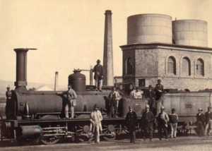 Locomotora de mercaderías y depósito de agua en la estación de Córdoba. 1867. Copia a la albúmina. JOSÉ SPREAFICO..png